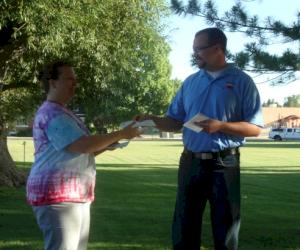 Pacific States Team Member Davy Crockett presents check to Event Chair Lorene Moore